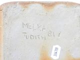 a piece of bread with writing on it sitting on a table