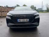 the front end of a black audi vehicle parked in a parking lot