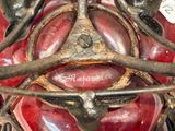 a close up of a red motorcycle with a metal frame