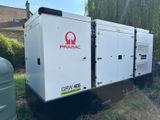 an image of a group of generators sitting on top of a grass covered field
