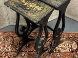 pair of antique black and gold side tables on a rug