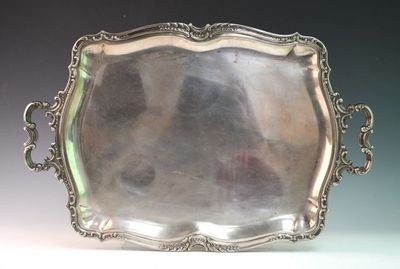 an antique silver tray with handles and handles on a table
