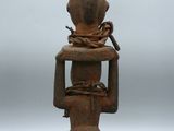 an old wooden statue of a woman with a bird on her head