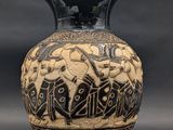 a black and white vase with a design on it