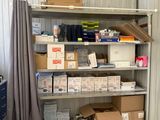 many boxes and boxes on a shelf in a storage room
