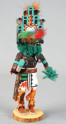 an image of a figurine of a native american man with feathers on his head