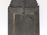 an old wooden plaque hanging on the wall with a cross on it