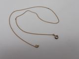a gold chain with a small diamond pendant on it