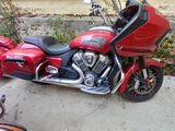 a red motorcycle that is parked on the side of the road