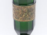 a green glass vase with a gold band around it