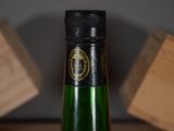 a bottle of wine sitting on a table next to a block of wood