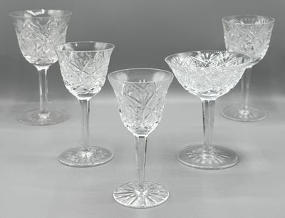 six verres à vin en cristal sont alignés sur une table