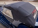a blue car with a black roof parked in a parking lot