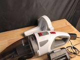 a vacuum that is sitting on a table next to a cell phone
