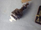 a small bell that is on a table next to a book