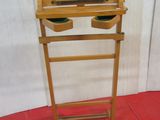 a small wooden stand with two bowls on it