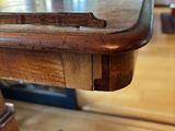 a close up of a table with a chair in the background