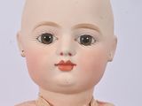 a small doll with a pink dress on it ' s head