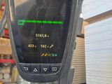 a close up of a parking meter with a lot of boxes in the background