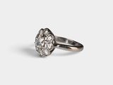 a close up of a diamond ring on a white surface