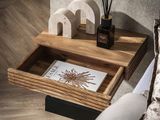 a wooden table with a book and a candle holder on it