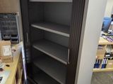 a large open book shelf in the middle of a room