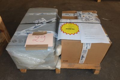 many boxes on a pallet with a price tag on them
