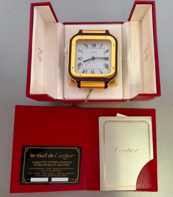 a box with a clock inside of it on a table
