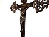 a statue of jesus on a cross with a crown on it