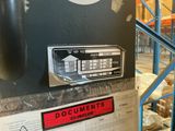 a picture of a machine in a warehouse with a sign on it