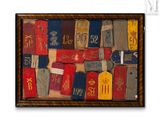 a picture of a picture of old luggage tags on a wall