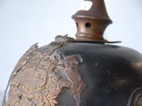 a black vase with a gold decoration on it