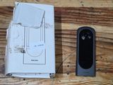 a remote control sitting next to a box on a wooden floor