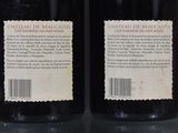 two bottles of wine that are sitting on a table