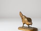 bronze sculpture of a chicken on a wooden base on a white background