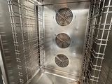 a metal oven that is open and has a lot of food inside of it