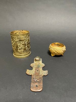 three different types of brass items are displayed on a black surface