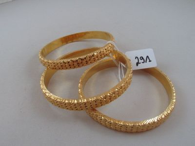 three gold rings with a price tag on them sitting on top of a table