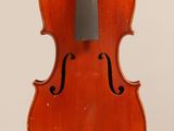 an old violin with a bow hanging from it ' s back