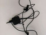a black cord that is connected to a charger on a table