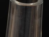 clear glass vase on a black table with a black background