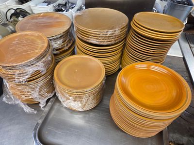 a lot of plates that are sitting on a table