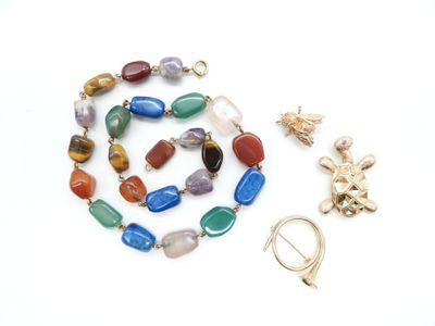 an assortment of jewelry including a cross, a necklace, and a broochet