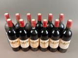 six bottles of wine lined up in a row on a table