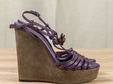 a close up of a pair of purple shoes on a wooden table
