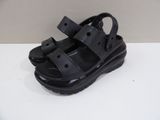 black sandals on a white table with a white wall in the background