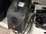 a black blower sitting on top of a shelf next to a laptop