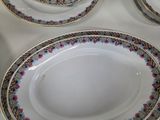a white table topped with plates and bowls on top of a table