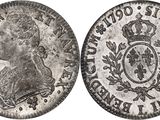 a close up of a coin with a crown on it