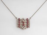 an antique diamond and ruby pendant on a chain